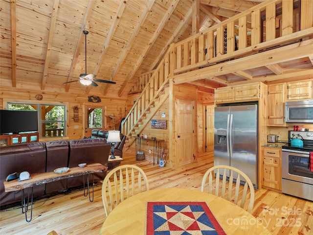 dining area with wood ceiling, light hardwood / wood-style floors, and wood walls