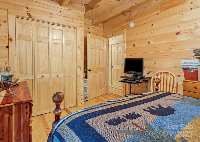 bedroom featuring wood ceiling, light wood-type flooring, beamed ceiling, and wood walls