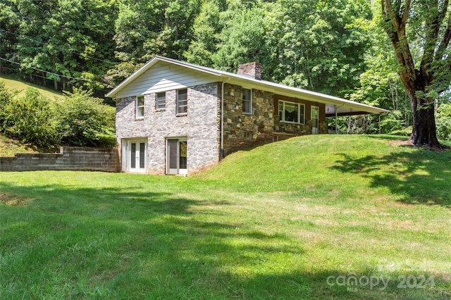 view of side of home featuring a yard