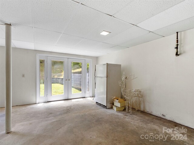 empty room with a paneled ceiling and french doors