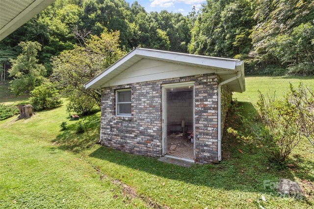 view of outdoor structure featuring a lawn