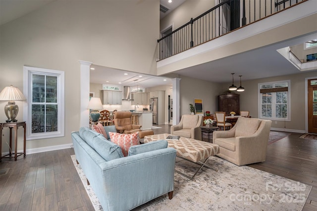 living room featuring a high ceiling and hardwood / wood-style floors