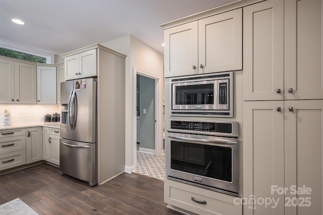 kitchen with white cabinets, dark hardwood / wood-style flooring, and stainless steel appliances