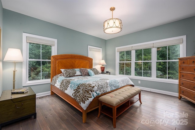 bedroom with dark hardwood / wood-style floors