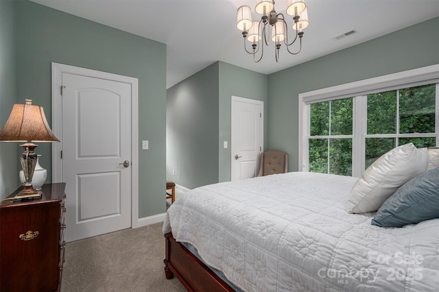 carpeted bedroom featuring a chandelier