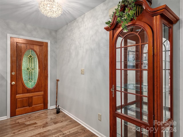 entrance foyer with a notable chandelier and light wood-type flooring