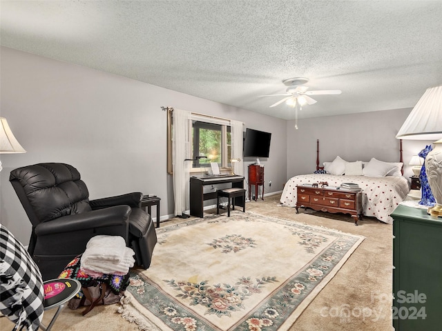 bedroom featuring ceiling fan, light colored carpet, and a textured ceiling