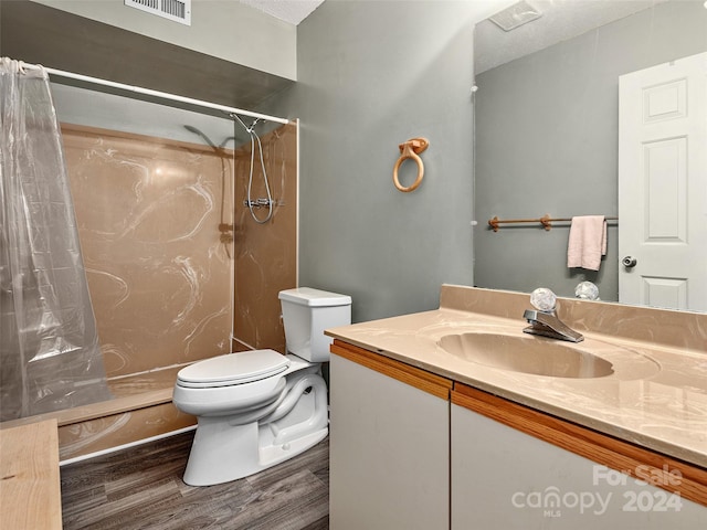 bathroom featuring hardwood / wood-style floors, vanity, toilet, and a shower with shower curtain