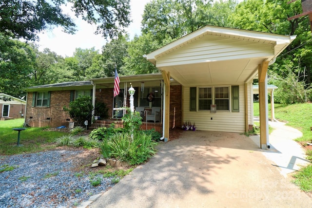 view of front of property with a porch and a carport