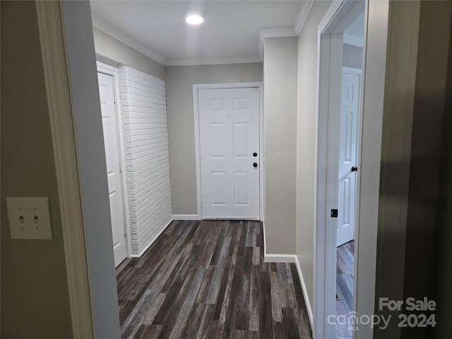 hallway featuring baseboards, ornamental molding, and dark wood-type flooring