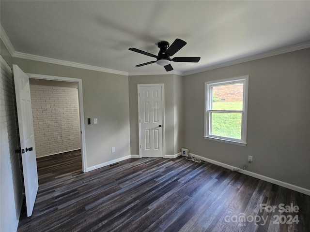 unfurnished bedroom with a ceiling fan, dark wood finished floors, crown molding, and baseboards