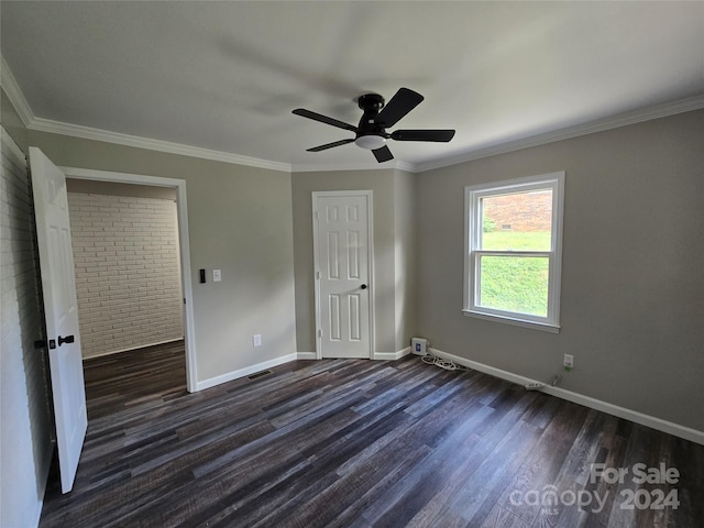 unfurnished bedroom with dark wood-style floors, a ceiling fan, a closet, crown molding, and baseboards
