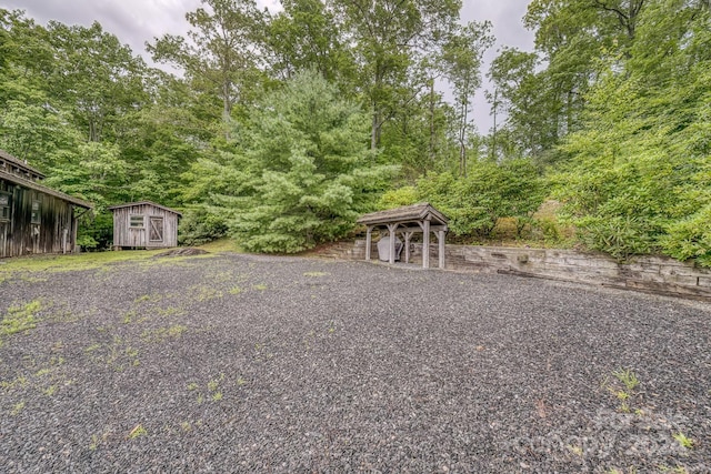 view of yard with a storage shed and an outbuilding