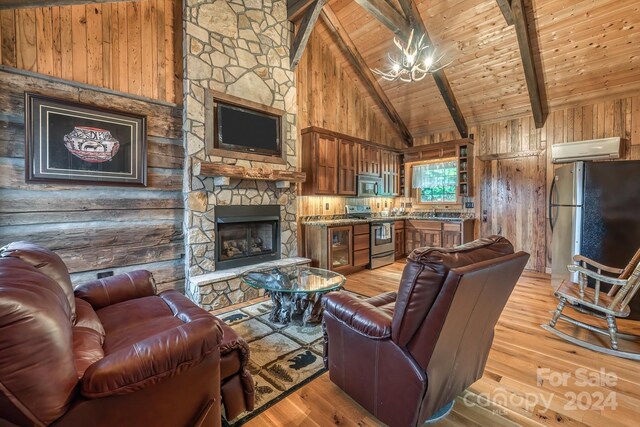 living room featuring light hardwood / wood-style floors, beamed ceiling, high vaulted ceiling, and wood walls