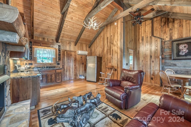 living area with light wood finished floors, wooden walls, wooden ceiling, beamed ceiling, and an AC wall unit