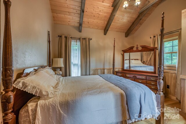 bedroom featuring vaulted ceiling with beams and wooden ceiling