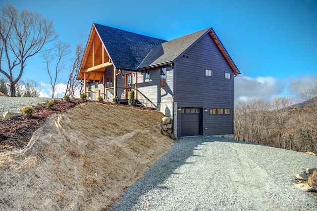 view of home's exterior with covered porch and a garage