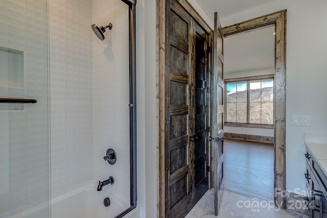 bathroom featuring vanity, wood-type flooring, and shower / bathtub combination