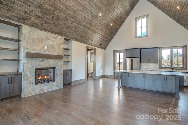 kitchen featuring light countertops, dark wood-type flooring, a kitchen island, and freestanding refrigerator