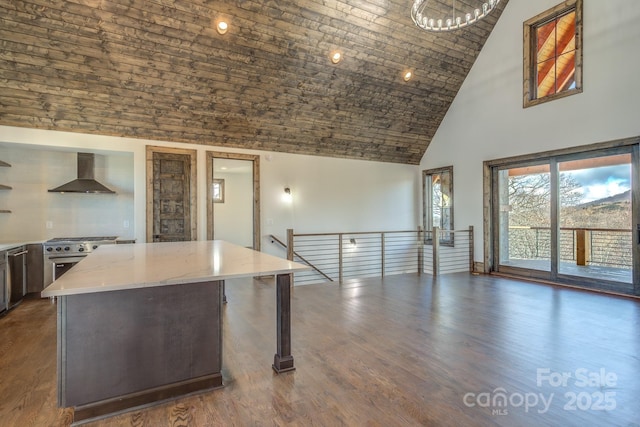 kitchen with wall chimney exhaust hood, dark wood-type flooring, high vaulted ceiling, stainless steel gas range oven, and a kitchen breakfast bar