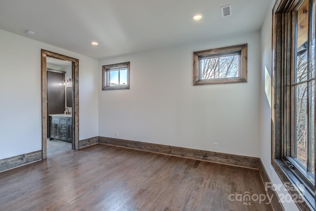 unfurnished room featuring dark wood-style flooring, recessed lighting, and baseboards