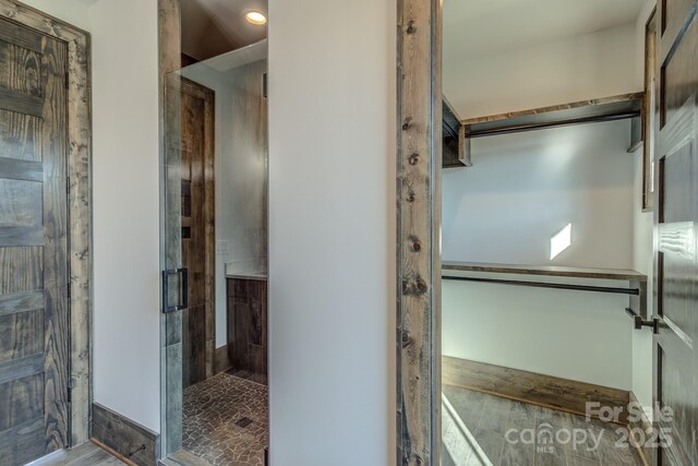 full bathroom featuring a closet, a shower stall, and vanity