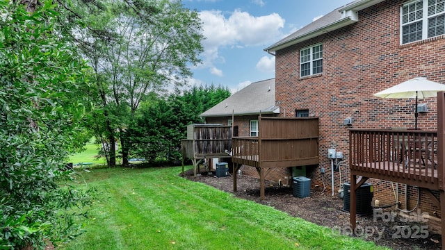 view of yard featuring central AC unit and a wooden deck