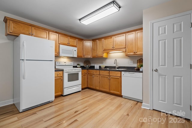 kitchen featuring light hardwood / wood-style floors, white appliances, and sink