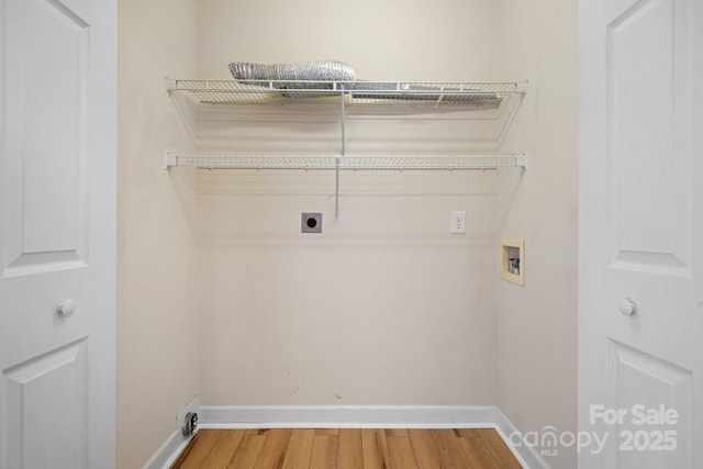 washroom with wood finished floors, baseboards, hookup for an electric dryer, laundry area, and washer hookup