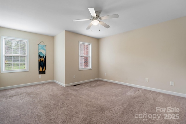 carpeted empty room with plenty of natural light, baseboards, and ceiling fan