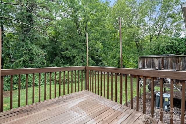 deck with a yard and central AC