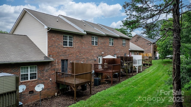 back of house with central air condition unit, a yard, and a wooden deck