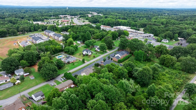 drone / aerial view featuring a wooded view