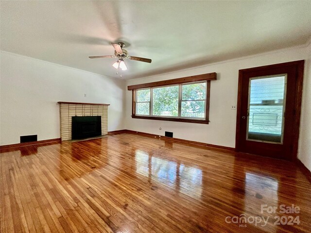 unfurnished living room featuring a fireplace, ceiling fan, and hardwood / wood-style floors