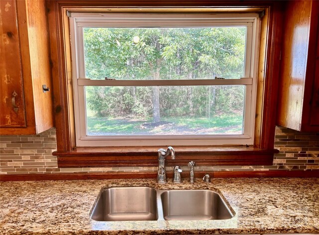 kitchen with sink, a healthy amount of sunlight, and tasteful backsplash