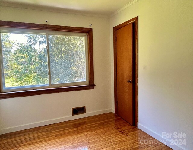 unfurnished room featuring light hardwood / wood-style floors