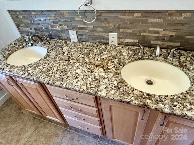 bathroom featuring backsplash, vanity, and tile patterned floors