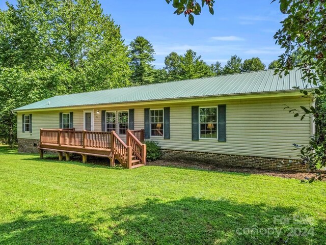 exterior space with a wooden deck and a front yard