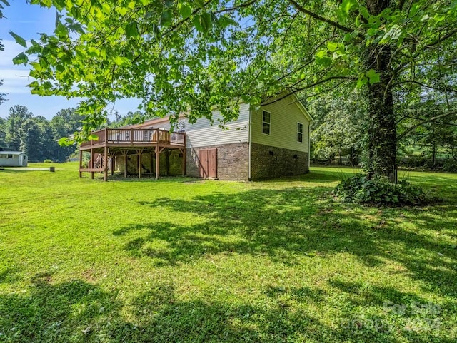 view of yard with a wooden deck