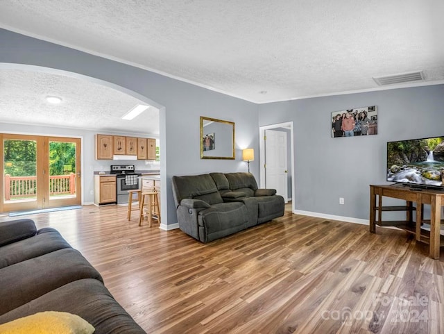 living room featuring light hardwood / wood-style flooring and a textured ceiling