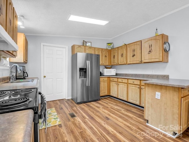 kitchen featuring a textured ceiling, stainless steel fridge, ornamental molding, and light wood-type flooring