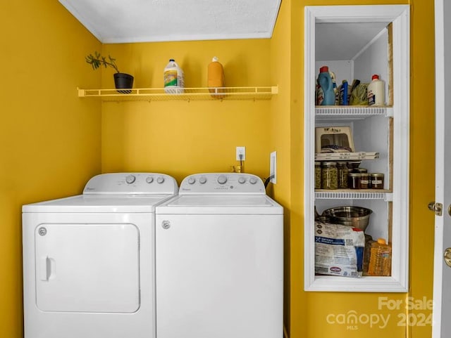 clothes washing area featuring washer and clothes dryer