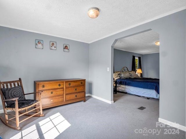 carpeted bedroom with a textured ceiling and ornamental molding