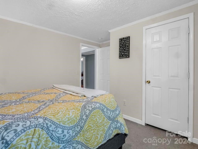 carpeted bedroom with ornamental molding and a textured ceiling