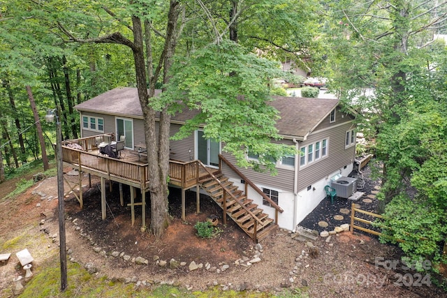 rear view of house with central AC unit and a deck