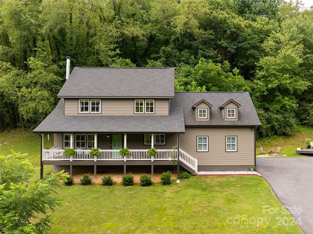 view of front of property with a porch and a front lawn