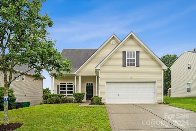 traditional home featuring driveway, a front lawn, and an attached garage