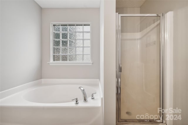 full bath featuring a shower stall and a bath