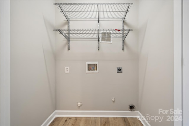 clothes washing area featuring hookup for a gas dryer, hookup for a washing machine, baseboards, and electric dryer hookup