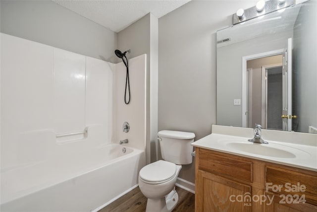 bathroom featuring a textured ceiling, bathtub / shower combination, toilet, visible vents, and vanity